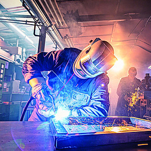 The,Two,Handymen,Performing,Welding,And,Grinding,At,Their,Workplace