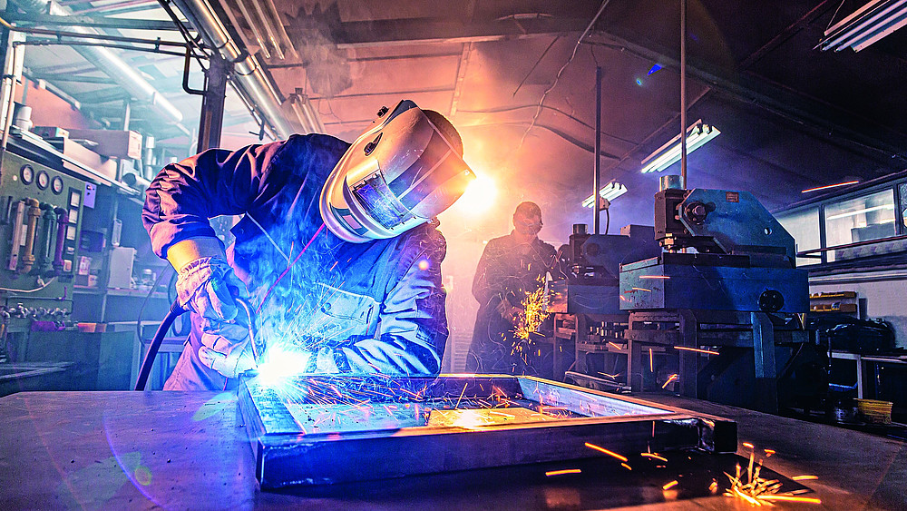 The,Two,Handymen,Performing,Welding,And,Grinding,At,Their,Workplace