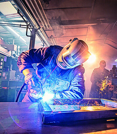 The,Two,Handymen,Performing,Welding,And,Grinding,At,Their,Workplace